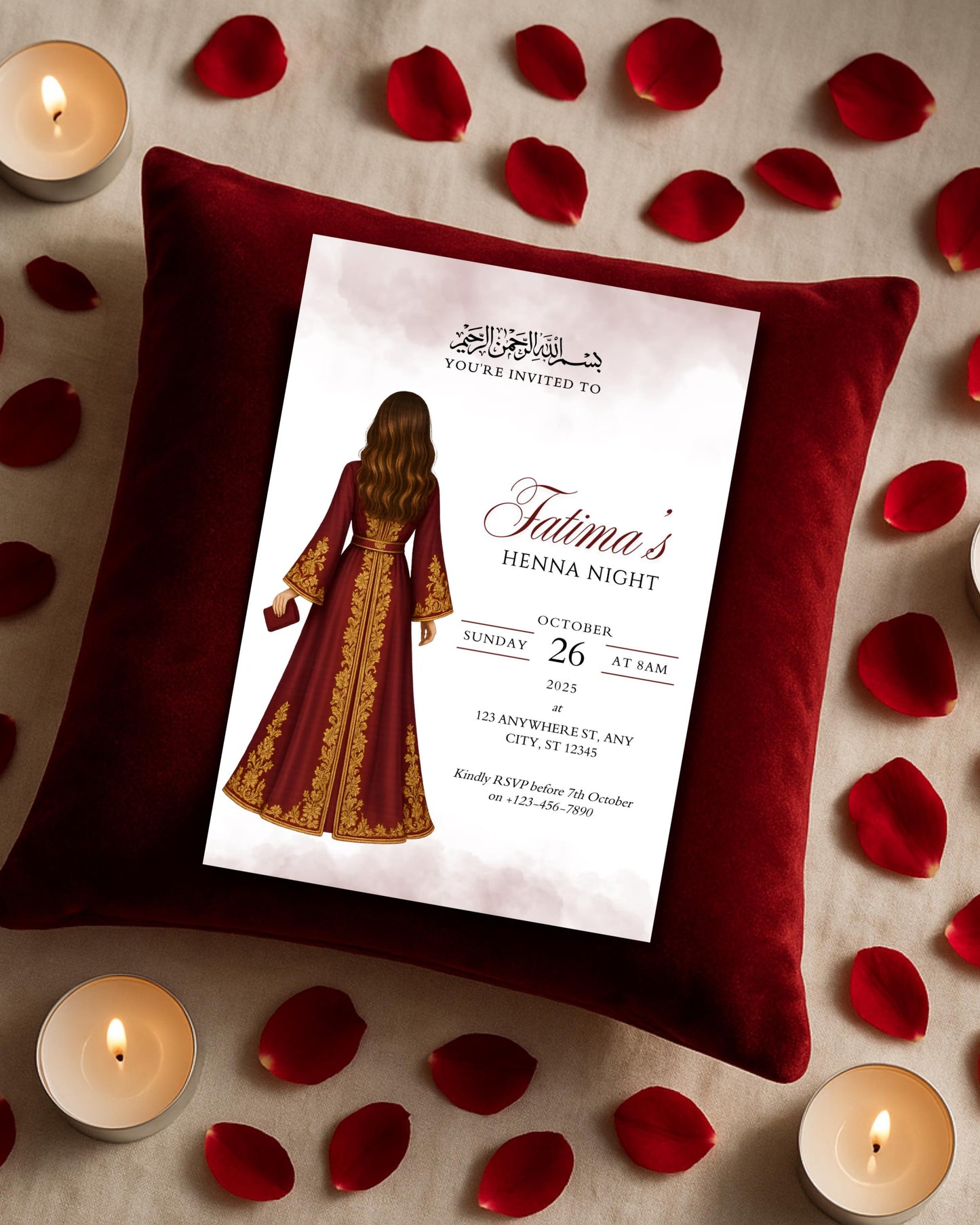 Henna night invitation card on a red pillow with candles and rose petals