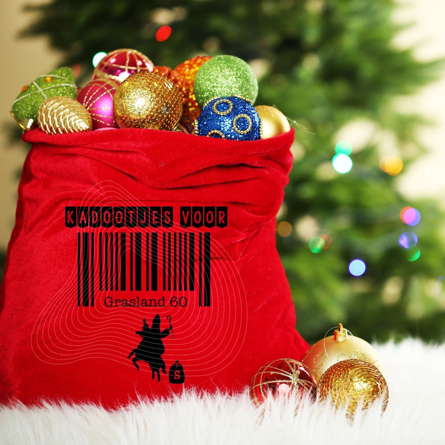 Red sack filled with Christmas ornaments in front of a decorated tree