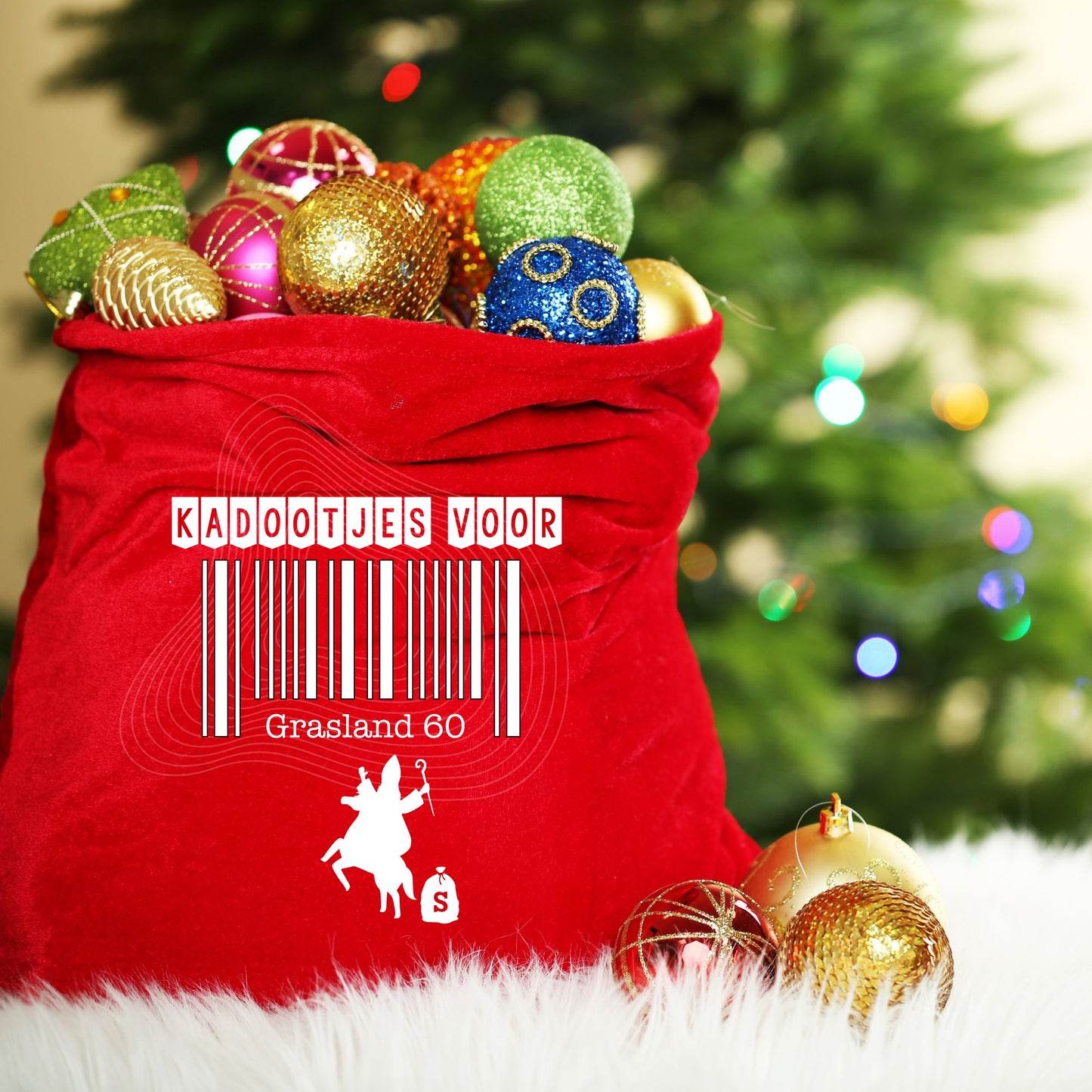 Red sack filled with Christmas ornaments in front of a decorated tree