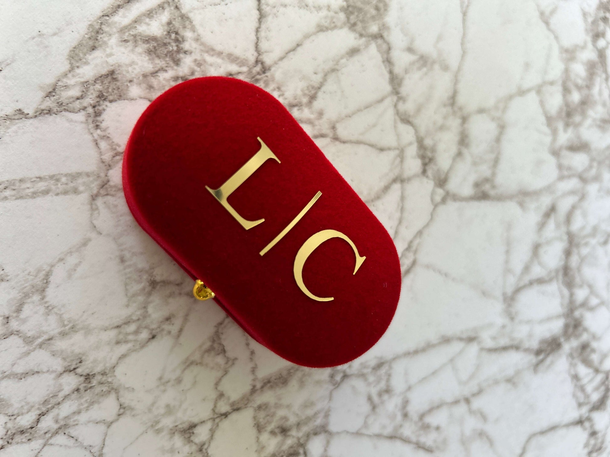 ring box red, with lid, black inside,