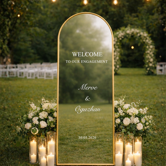 Decorative setup with a mirror, flowers, and candles in an outdoor setting.